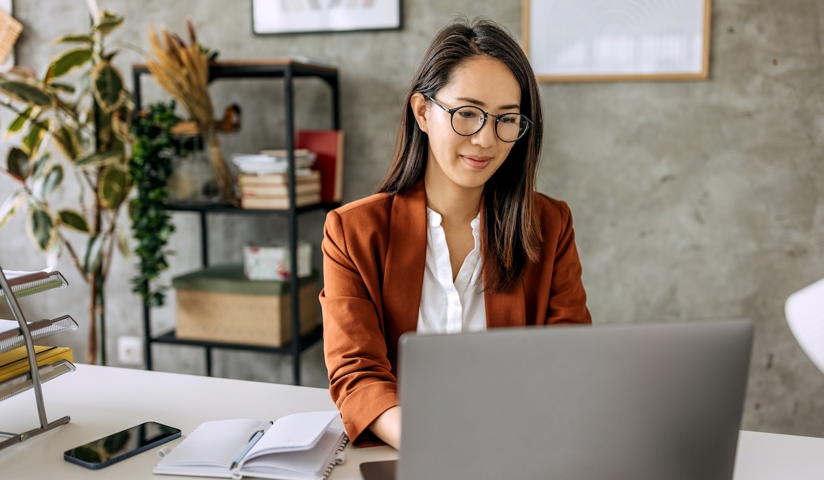 Well dressed beautiful mid adult businesswoman working from home office