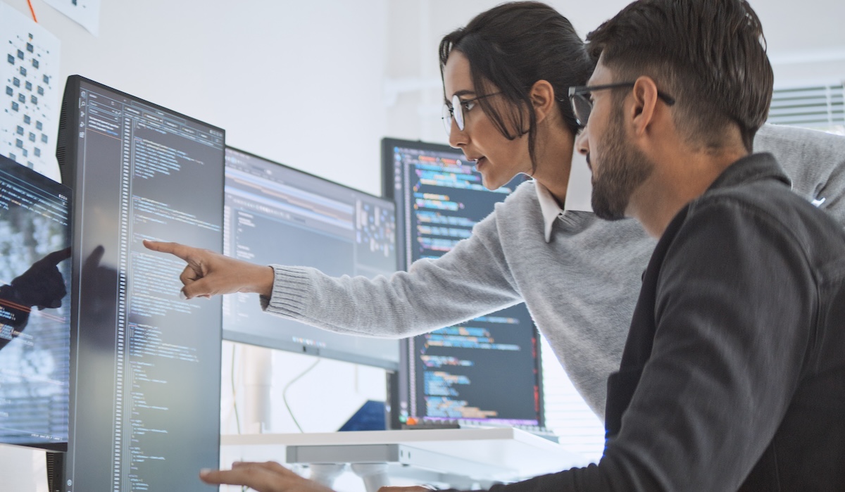 Hispanic Latin American couple, software engineer developer use computer, work on program coding together at home office. Programming language development technology, freelance job concept