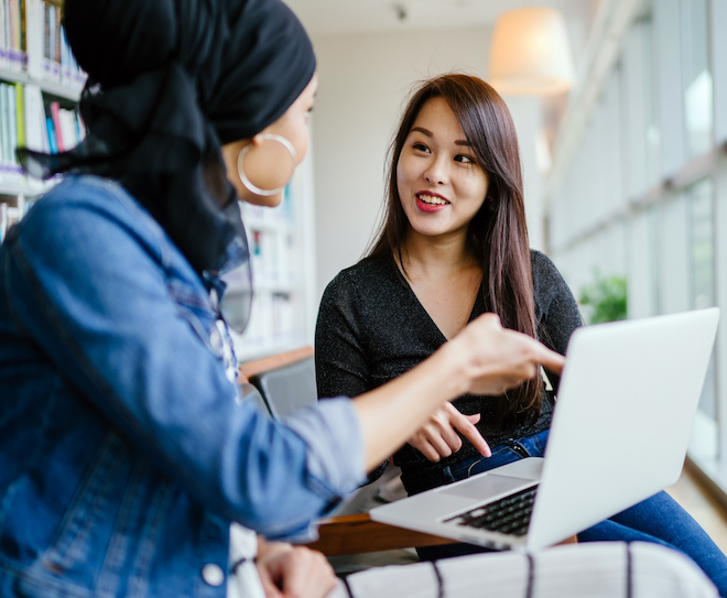 two-women-discussing-work-over-a-laptop